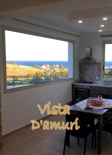 a large window in a kitchen with a dining room table at VISTA D'AMURI in Sciacca