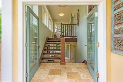 a hallway with a staircase in a house at Beautiful and Cheerful Hale Mokolea in Lanikai in Kailua