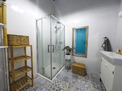 a bathroom with a glass shower and a sink at Cool Canaria in Agaete