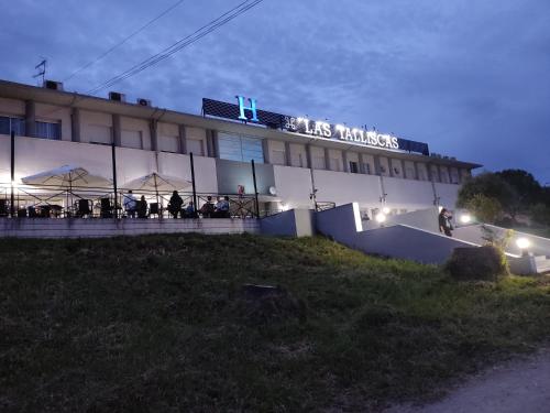 a building with people standing outside of it at night at Las Talliscas in Casas de Don Gómez