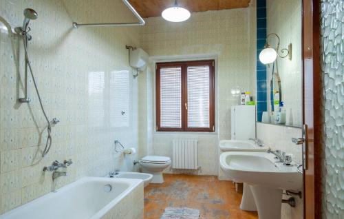 uma casa de banho com 2 lavatórios, uma banheira e um WC. em Tempio Pausania Solar private apartment 30 minutes from the sea - Appartamento solare a 30 minuti dal mare em Tempio Pausania