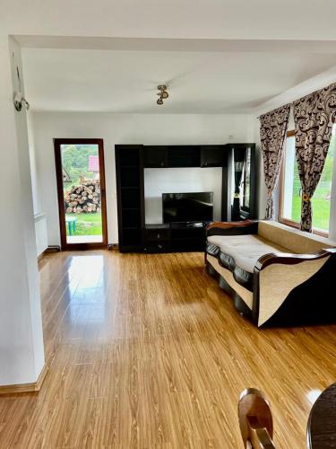 a large room with a bed and a fireplace at Casa Rus in Leordina