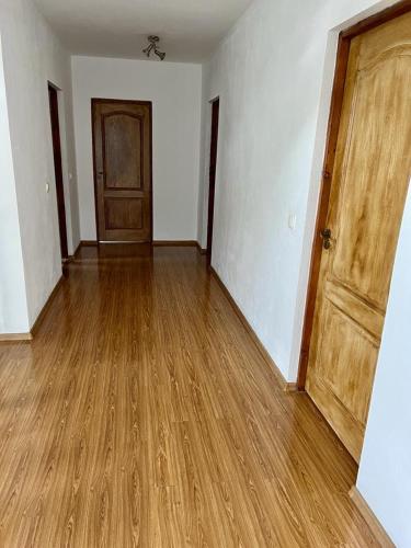 an empty room with a wooden door and wooden floors at Casa Rus in Leordina