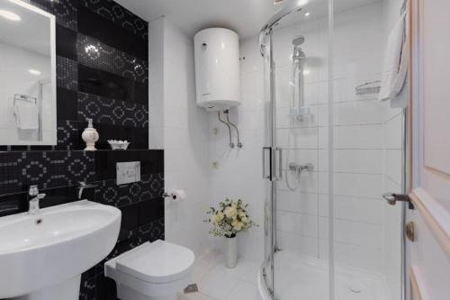 a bathroom with a toilet and a sink and a shower at Hotel 19 Batumi in Batumi