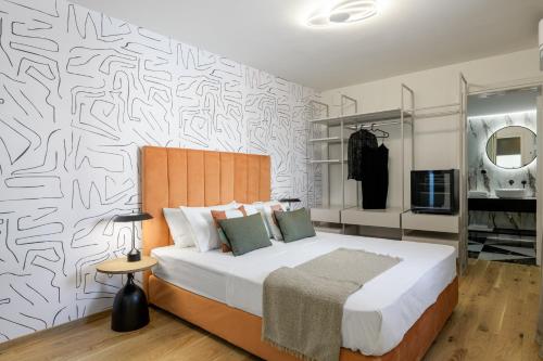 a bedroom with a bed and a wall with a pattern at Your 4 bdrm Dream House Acropolis View & Jacuzzi in Athens