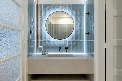 a bathroom with a sink and a mirror at Your 4 bdrm Dream House Acropolis View & Jacuzzi in Athens