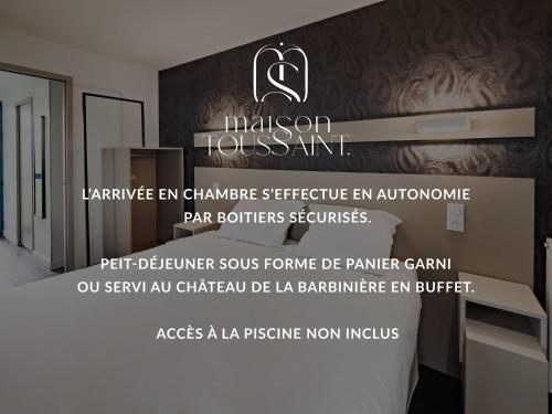 a hotel room with a bed with a sign on it at Maison Toussaint in Saint-Laurent-sur-Sèvre