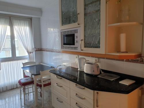 a kitchen with a sink and a counter top at Apartamento con garaje. Luminoso y confortable in Santander