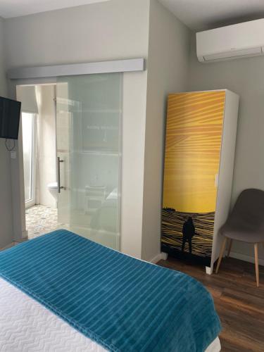 a bedroom with a bed and a glass door at Guest House Stories in Beja