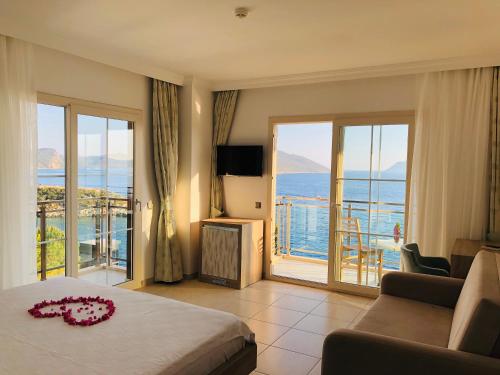 a bedroom with a bed and a view of the ocean at Narr Hotel in Kaş