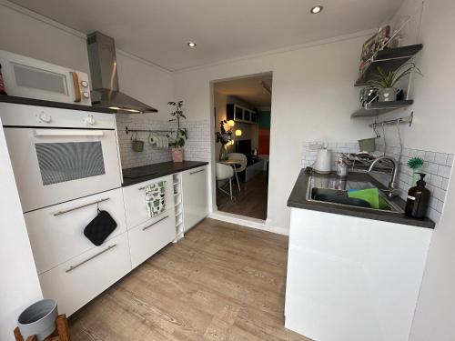 a kitchen with a sink and a stove top oven at The Studio by Hip Haus in Cleethorpes