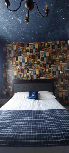 a bedroom with a bed with a wall covered in books at Binario Magic RistoHotel in Palazzago
