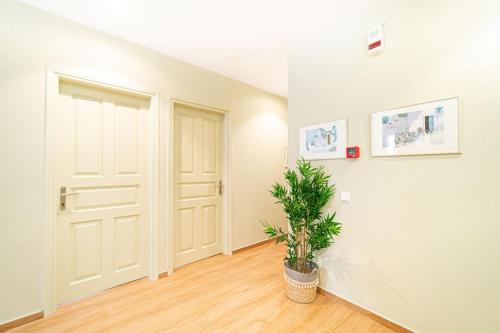 a hallway with a door and a potted plant at Antonia Hotel in Fira