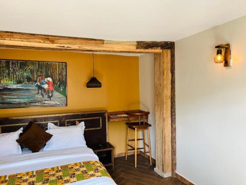 ein Zimmer mit zwei Betten und einem Gemälde an der Wand in der Unterkunft The Forest Resort - Lweza in Makindye