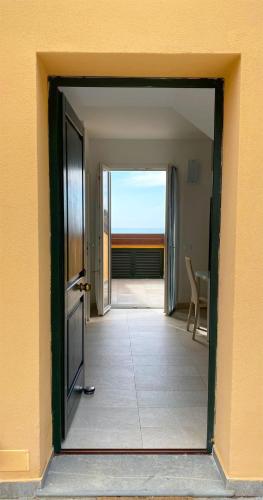 an open door to a room with a view of a patio at Estate Riomaggiore in Riomaggiore