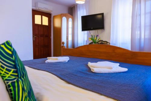 a bedroom with a bed with two pillows on it at Retel Vitez Vendégház in Sárospatak
