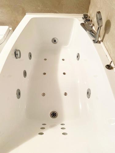 a white bath tub in a bathroom at Estate Riomaggiore in Riomaggiore