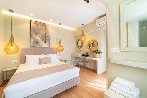 a bedroom with a bed and a desk in it at Antonia Hotel in Fira