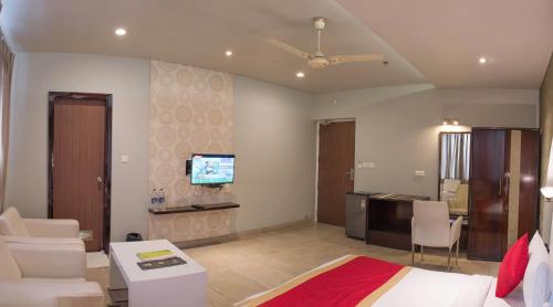 a bedroom with a bed and a living room at The Opal in Rāmpur