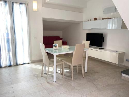 a dining room with a table and chairs and a television at Estate Riomaggiore in Riomaggiore