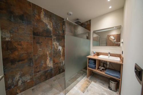 a bathroom with a sink and a shower at Villa Valtin in Le Valtin