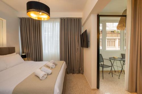 een slaapkamer met een bed met handdoeken erop bij Dema's Luxury Suites(E6) in Athene