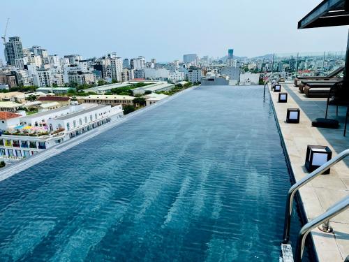 a large swimming pool on the top of a building at Estrella Boutique Hotel in Da Nang