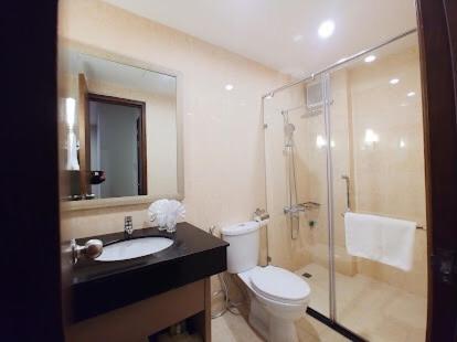 a bathroom with a toilet and a sink and a shower at Royal Lotus Hạ Long Resort & Villas in Ha Long