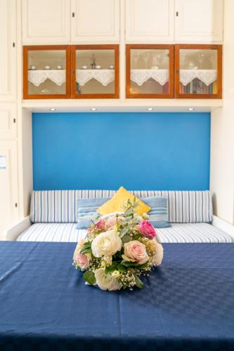a bouquet of flowers sitting on top of a bed at Monastero Santa Rosalia in Atrani