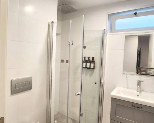 a bathroom with a shower and a sink at Assuta Residence in Ramat HaHayal, Tel Aviv in Tel Aviv