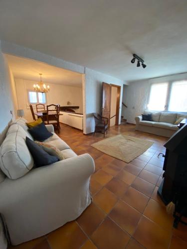 a living room with a white couch and a table at Cal Bisbe in Segura