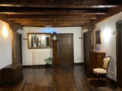 a hallway with a grandfather clock in a room at Txantxorena in Zubiri
