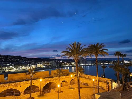 a view of a bridge and palm trees at night at Hostal Boutique Olvido 22 Adults Only in Peñíscola