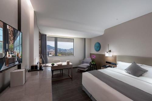 Postel nebo postele na pokoji v ubytování Genpla Hotel, Shenzhen Qianhai