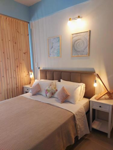 a bedroom with a bed with two pillows on it at Mpitzarakis Studio On the Beach in Agia Pelagia