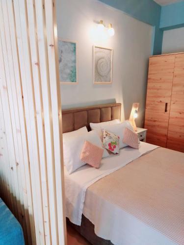 a bedroom with a bed with two pillows on it at Mpitzarakis Studio On the Beach in Agia Pelagia