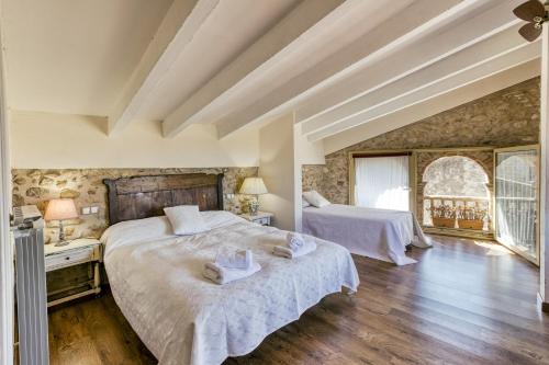 a bedroom with two beds with towels on them at Ca La Maria in Orriols
