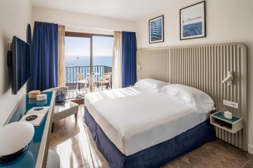 a hotel room with a bed and a balcony at Grand Hotel Diana Majestic in Diano Marina