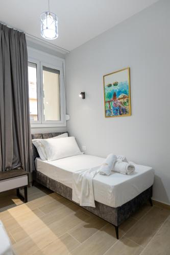 a bedroom with two beds and a window at Palm Side Hotel in Vlorë