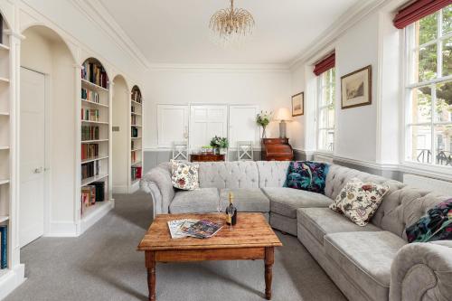 a living room with a couch and a table at 6 Bedroom City Centre Georgian Town House - Abbey & Baths-2 min walk in Bath