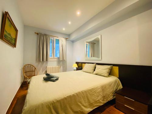 a bedroom with a bed and a chair in it at Casa Naranja - Centrally located, spacious, unique in Donostia-San Sebastián