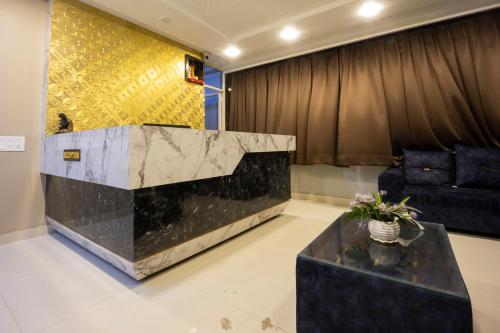 a lobby with a reception desk and a couch at Hotel Keptown in Jaipur
