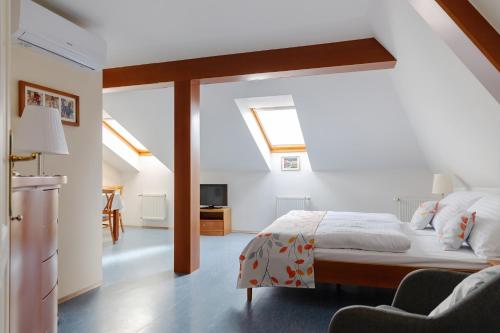 ein Schlafzimmer mit einem großen Bett mit Dachfenster in der Unterkunft Sibelius Apartments in Prag