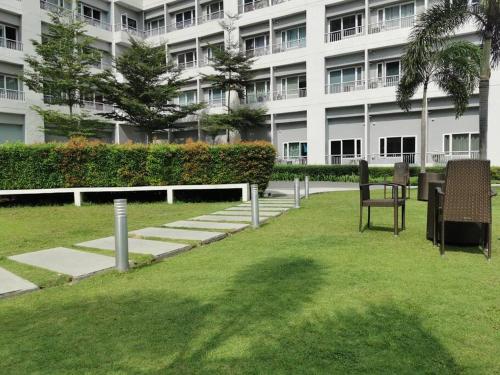 a park in front of a large building at Love@Grace Residences near BGC. in Manila