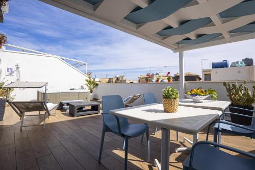 a patio with a table and chairs on a roof at Acquarò Suite in San Vito lo Capo