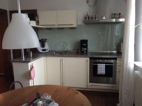 a kitchen with a sink and a stove top oven at Ferienwohnung Haumannshof in Xanten