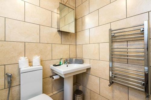 a bathroom with a sink and a toilet at Luxury Islington Apartment with Balcony Islington in London