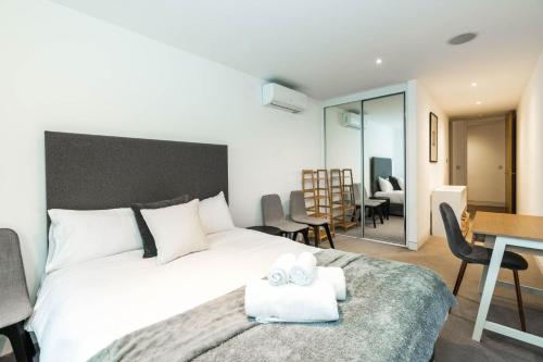 a bedroom with a bed with two towels on it at Apartment for 4 in the Heart of Shoreditch in London