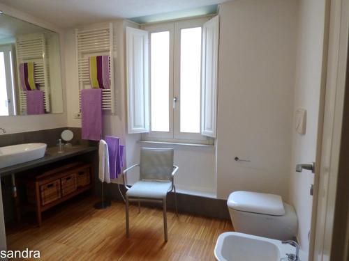 a bathroom with a sink and a toilet and a window at Innoi in Cagliari