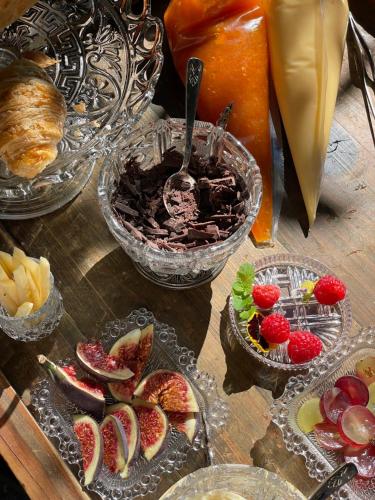 a table topped with bowls of fruit and desserts at Palazzo Albricci Peregrini in Como
